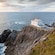 A building on a rocky cliff overlooking the ocean